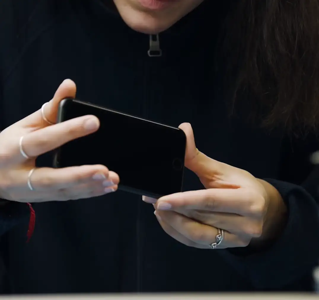 Person holding a smartphone with both hands